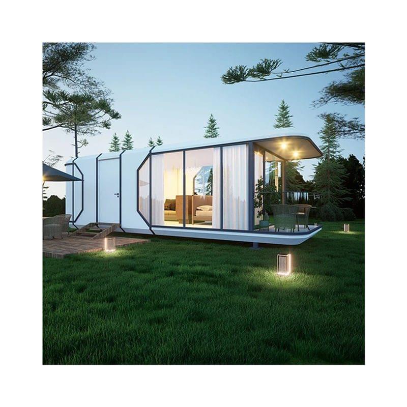A modern outdoor eco capsule house with large windows in a natural setting.