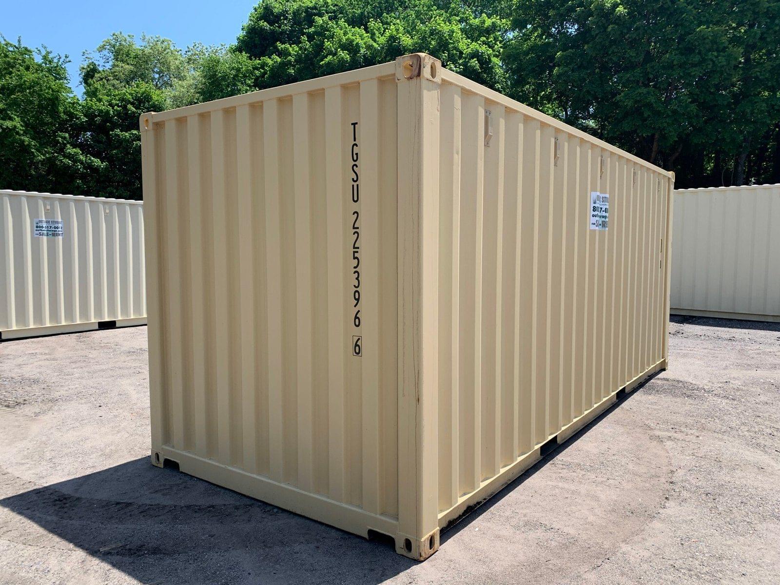 A new 20ft x 8ft shipping/storage container from KIRU, painted blue, sitting on gravel.