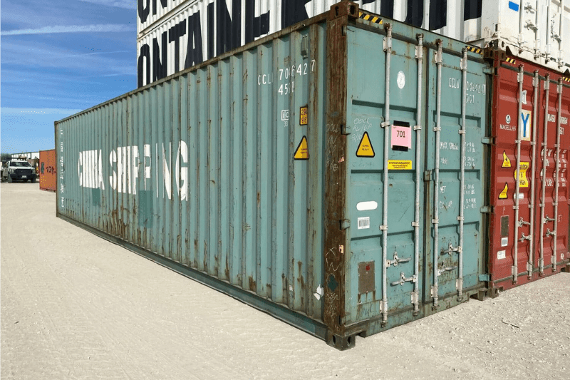 A 40 hc wind and watertight shipping container being delivered by truck to a site.
